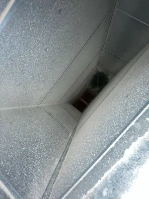 Sheet-metal duct with dust coating the interior