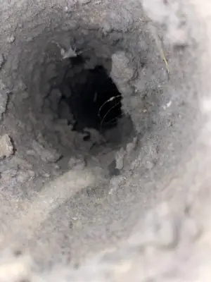 Dirty round air duct interior lined with dust