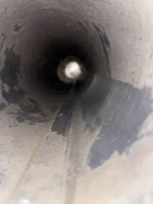 Inside a round air duct during inspection