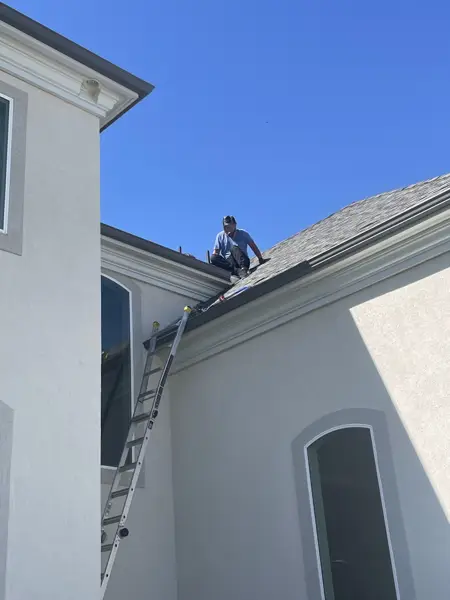 Mighty Ducts technician on the roof servicing a rooftop dryer vent